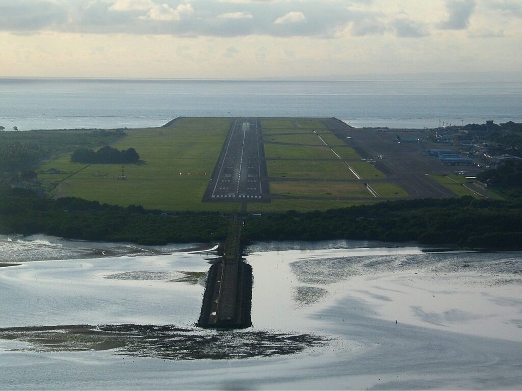 Landasan pacu Bandara I Gusti Ngurah Rai dengan latar belakang Samudra Hindia.